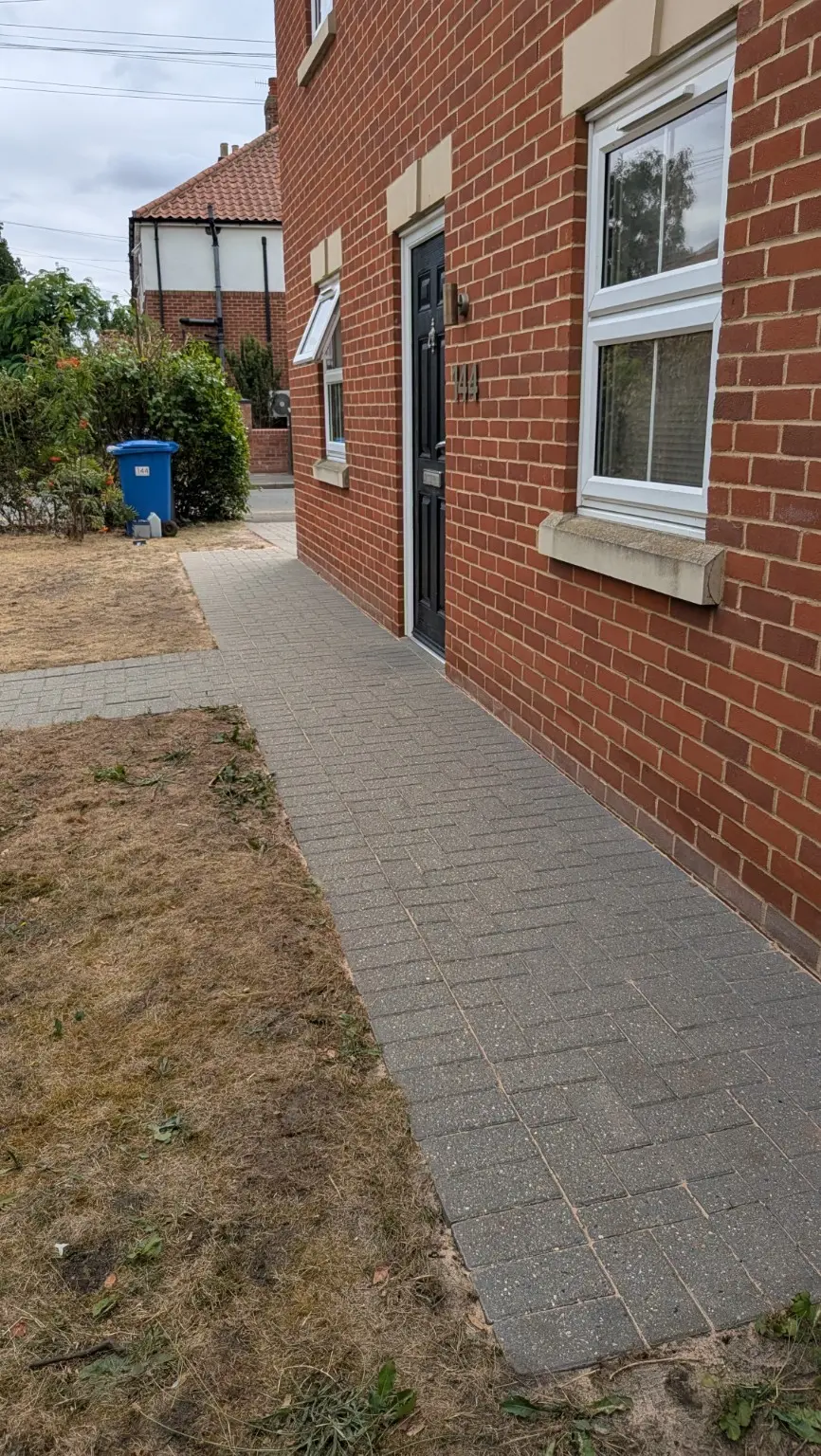 Block-paved side path after professional pressure washing and tidy-up