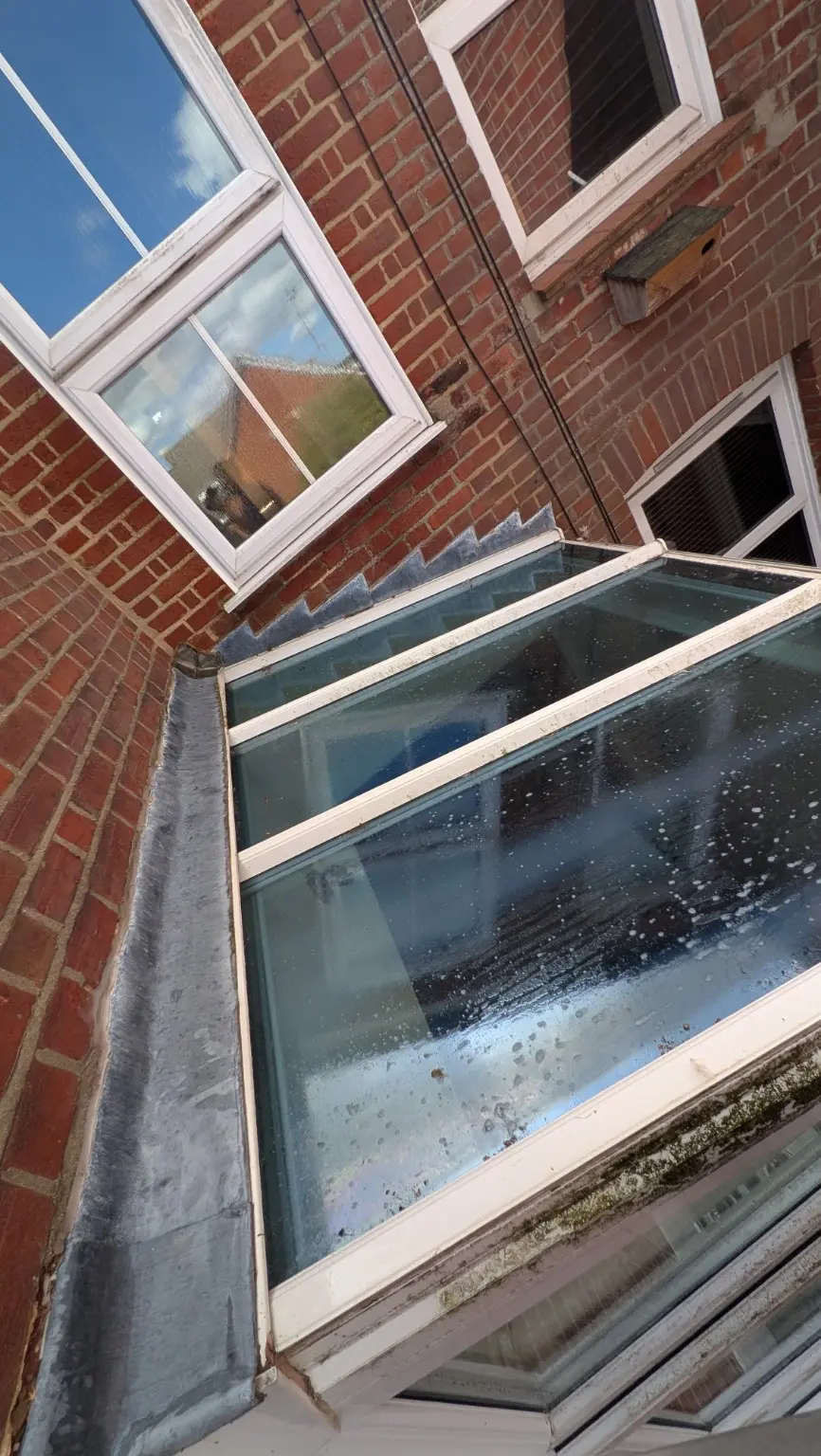 Conservatory glass roof during the removal of weather build-up