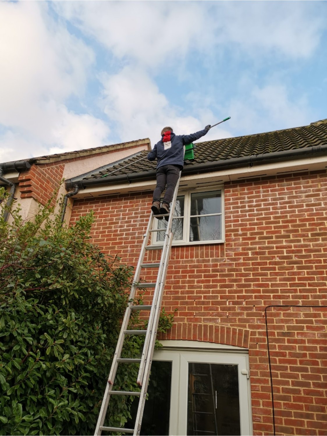 Roofline cleaning work from ladder