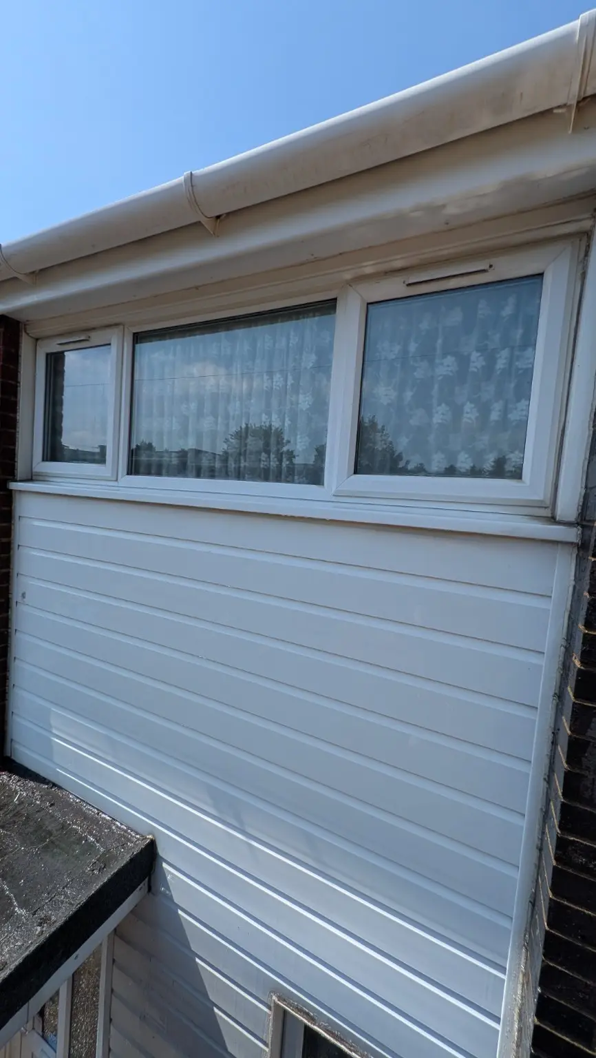 White exterior gutter and fascia after professional exterior cleaning
